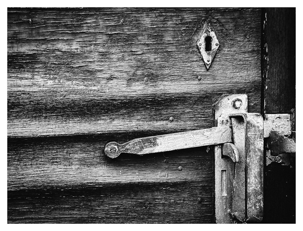 Aging wooden door, in black and white. 