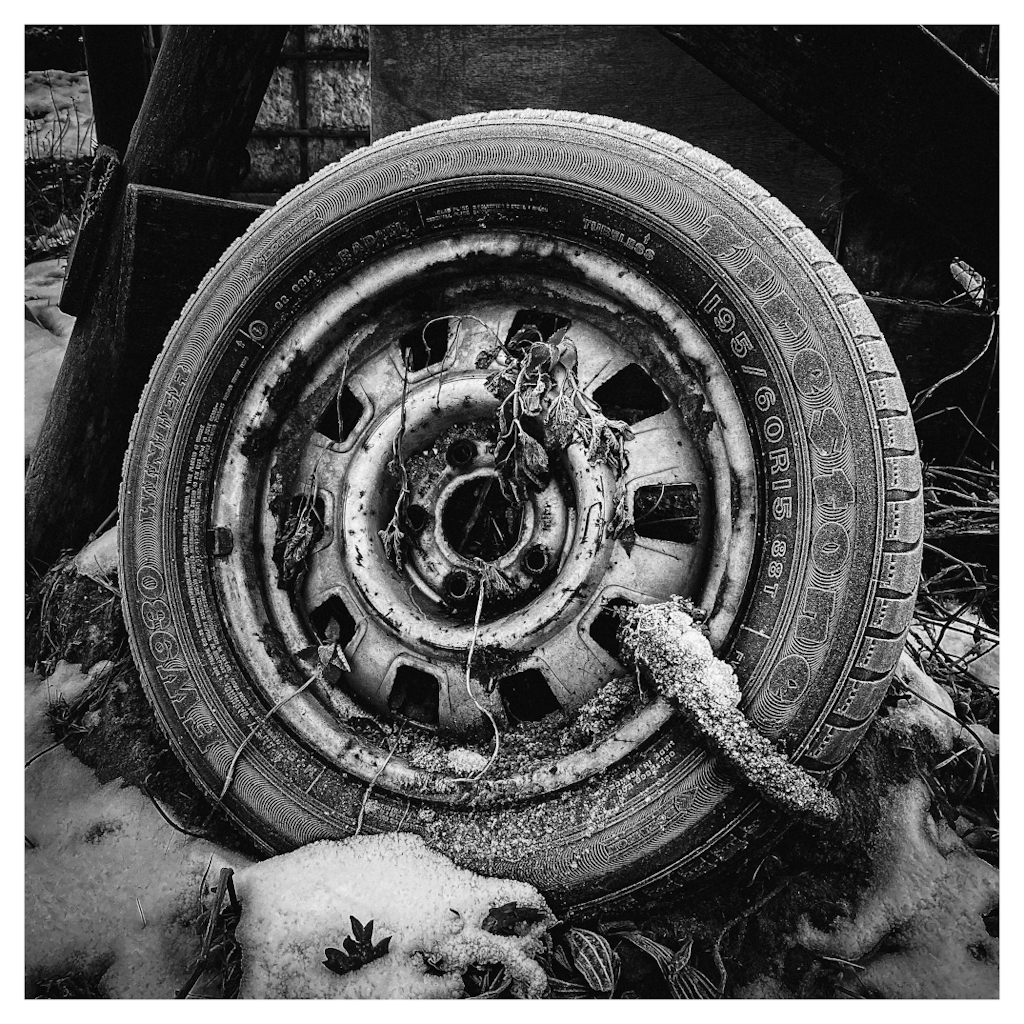 Overgrown car tire in the snow
