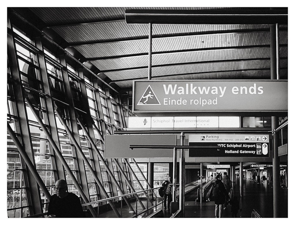 Walkway ends sign hanging in an airport