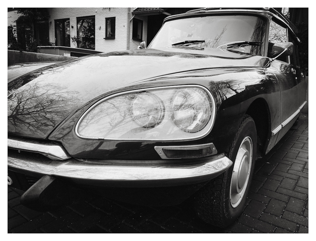 Gleaming Citroën DS, photographed from the front. Shown in black and white. 