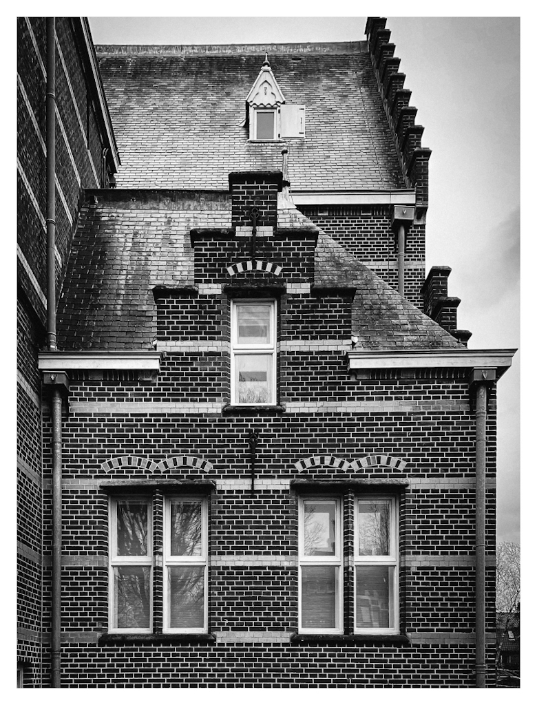 Facade of an old building, in black and white. 