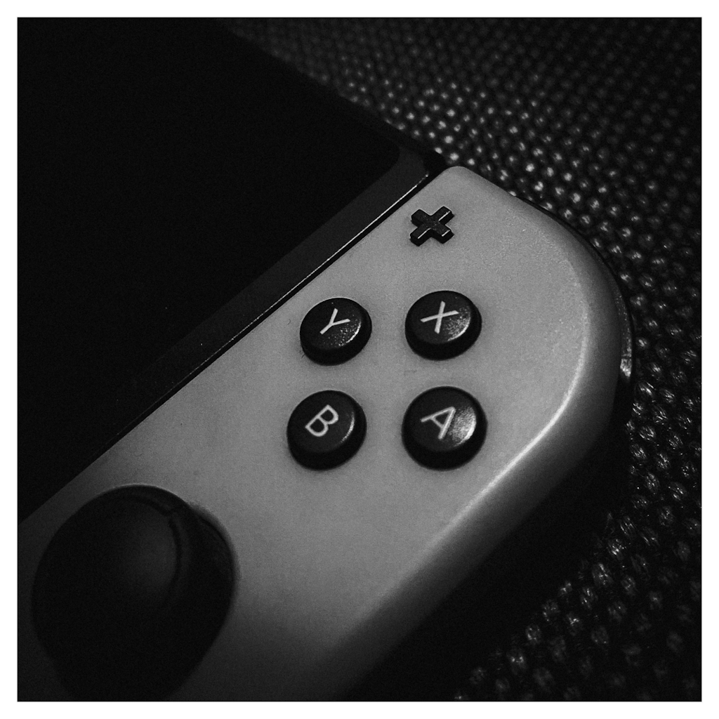 Detail of a Nintendo Switch, with the X, Y, A, B buttons in the center 